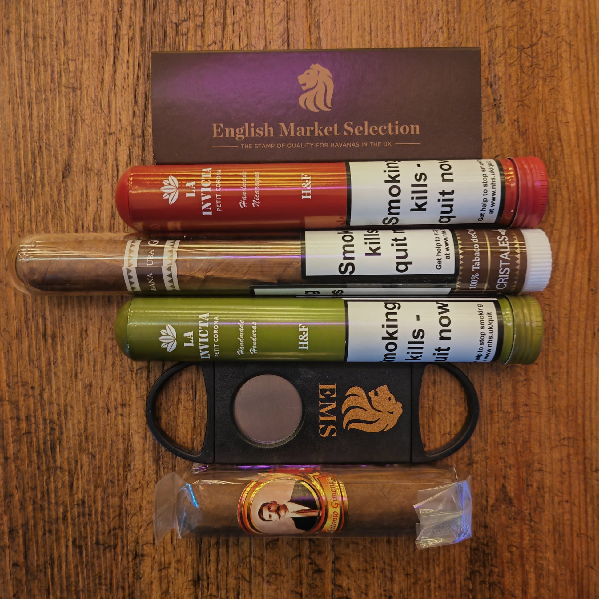 Cigars and a cutter on a wooden surface with 'English Market Selection' branding.