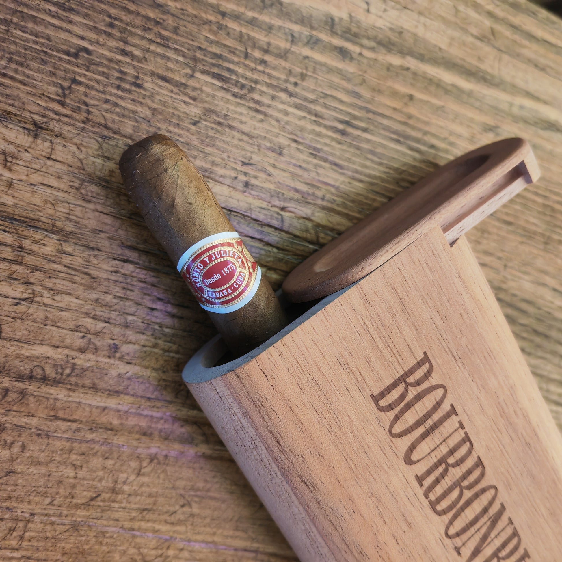Cigar with a label on a wooden coaster, placed on a wooden surface