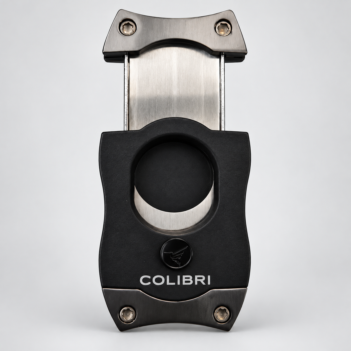 A black and stainless steel cigar cutter with the brand name 'COLIBRI' printed on the front, set against a light gray background.