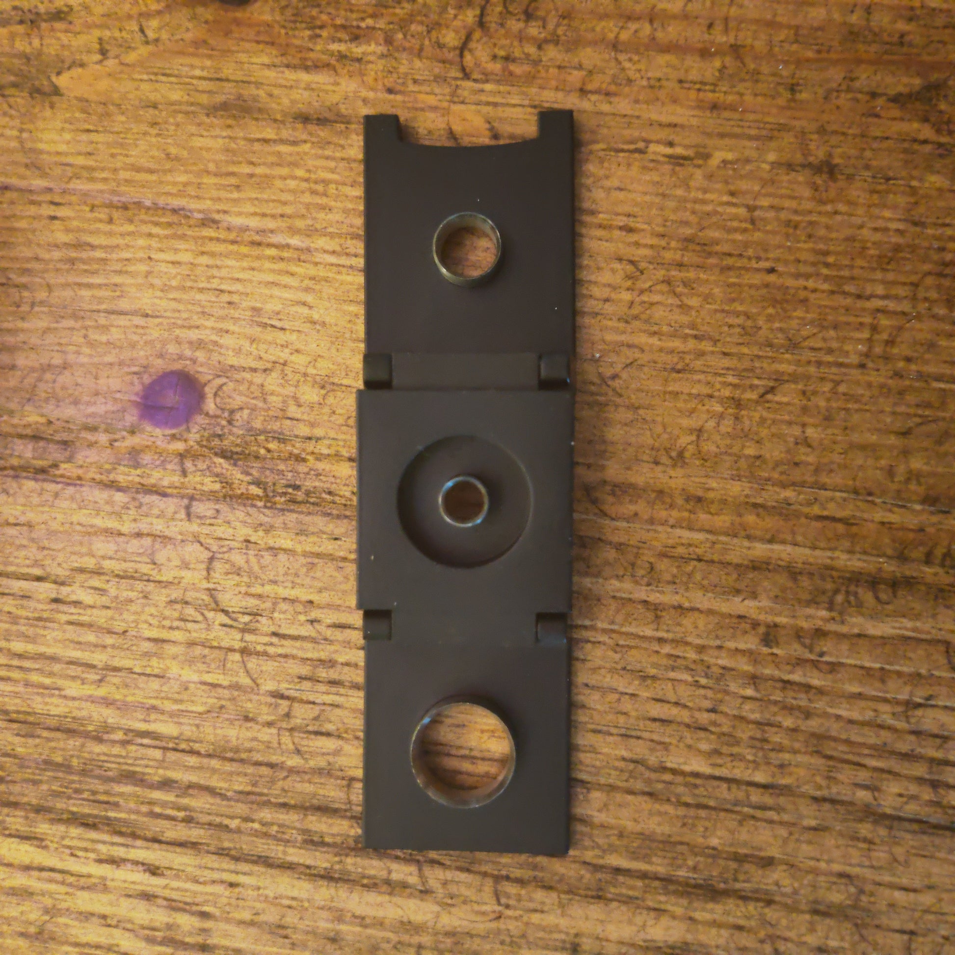 Black metal Cigar cutter on a wooden surface