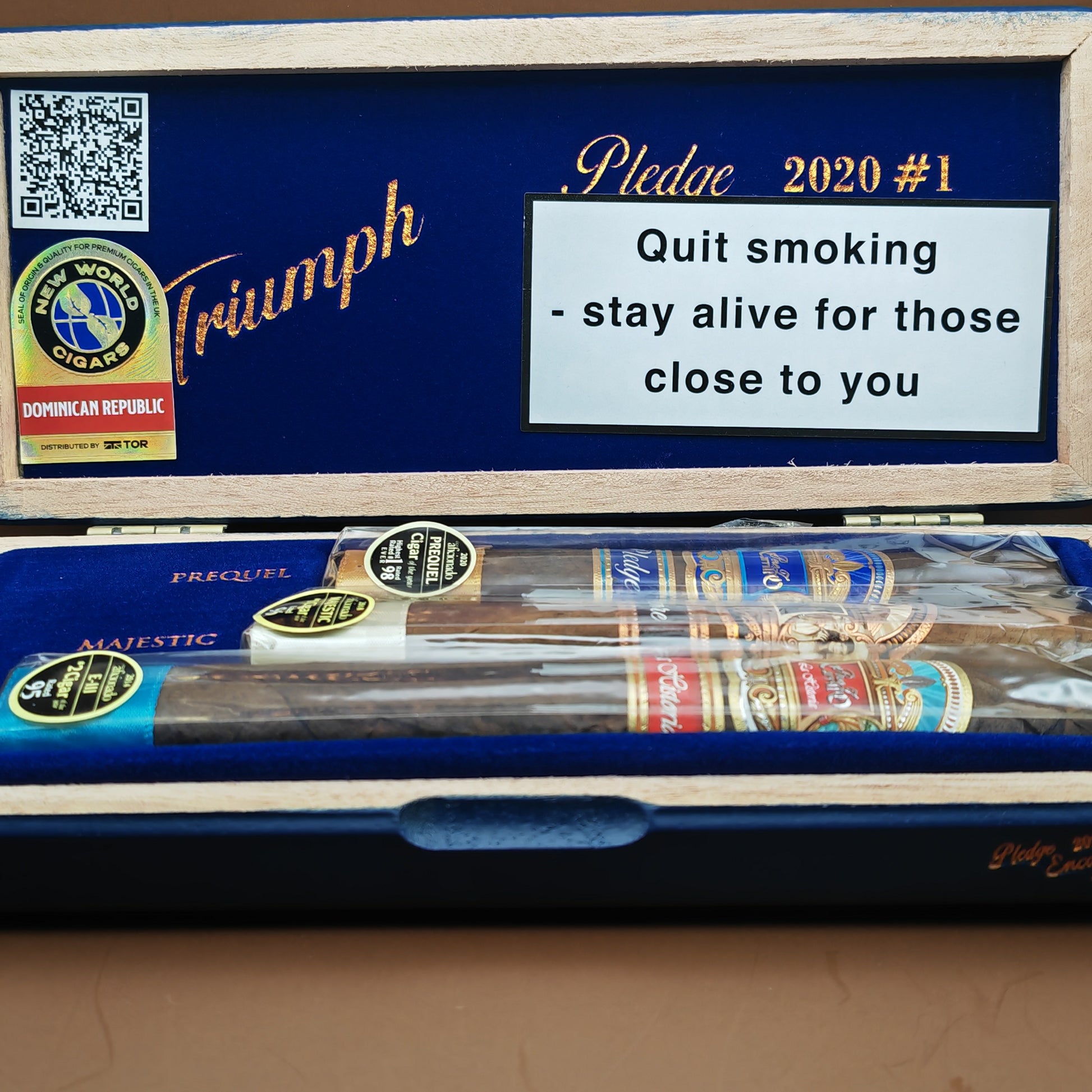 Cigar box with cigars inside, featuring a message about smoking cessation on a blue background.