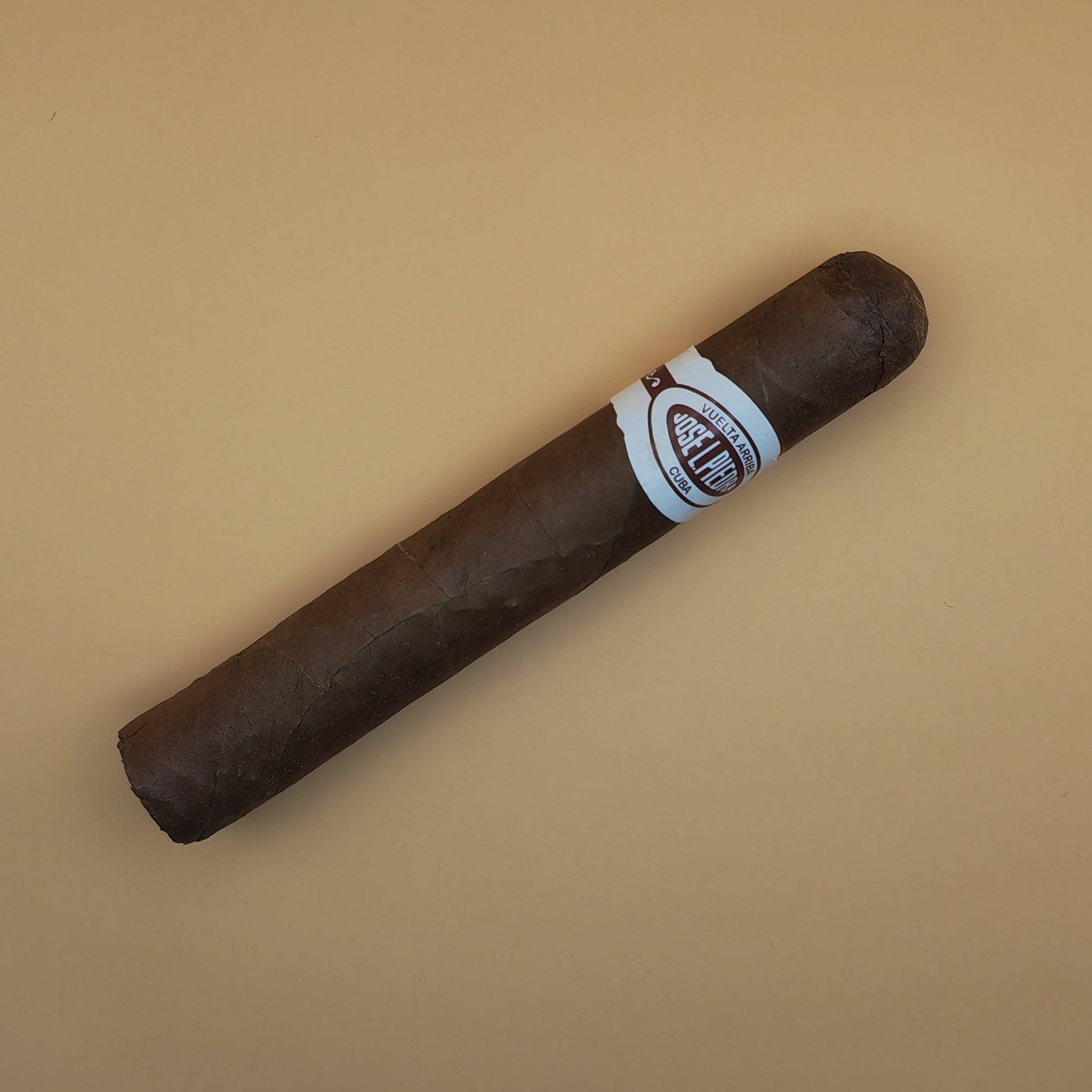 Cigar with a label on a beige background