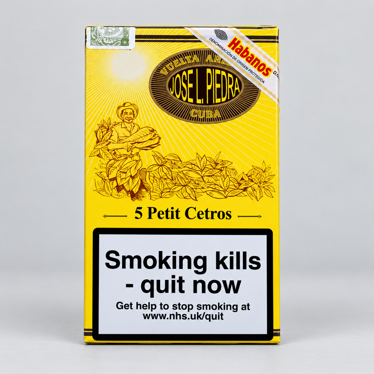 A pack of Josel Piedra Petit Cetro cigars on a light gray background. The packaging is bright yellow with black illustrations of a man holding flowers and the text '5 Petit Cetros'.