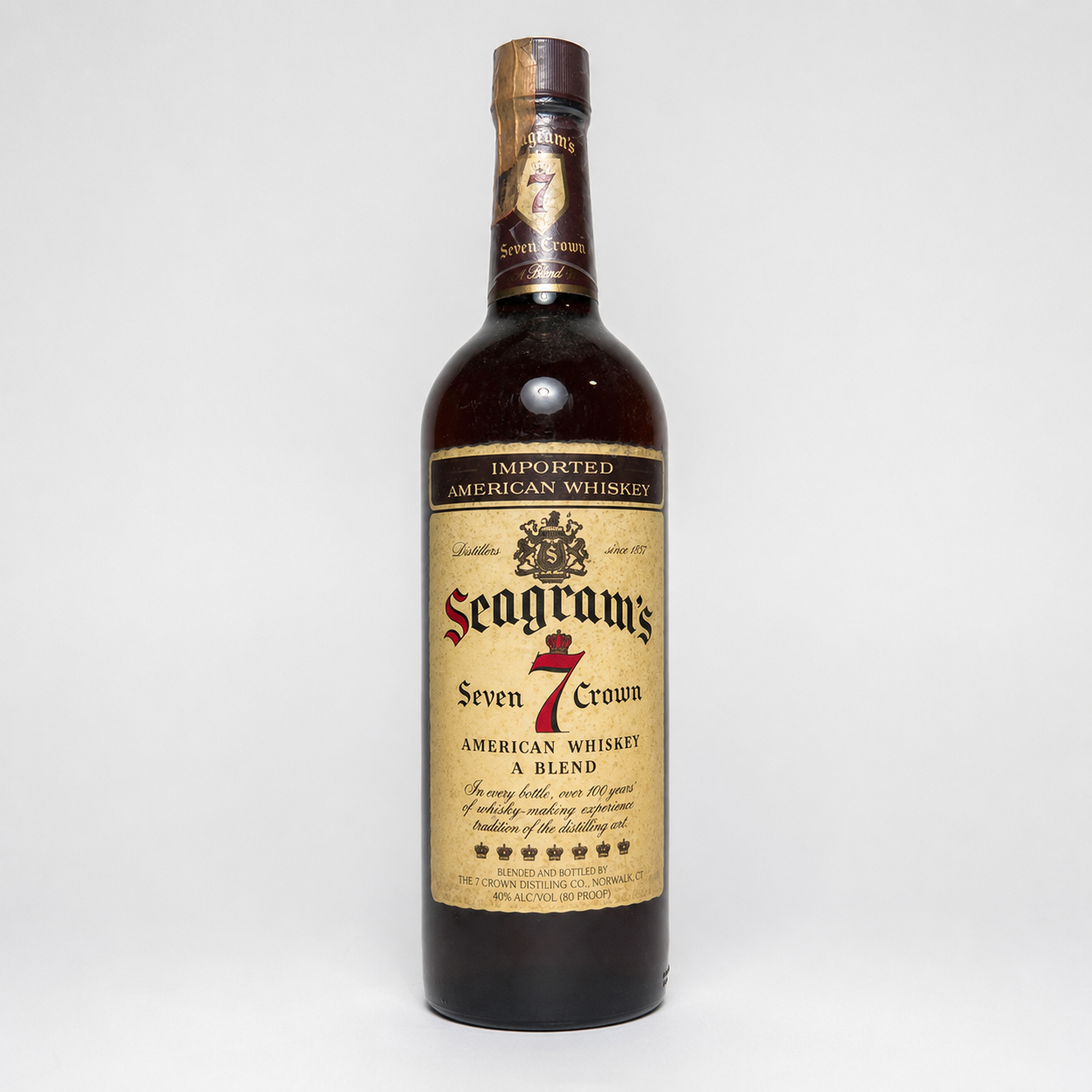 A bottle of Seagram's Seven Crown American Whiskey on a light gray background.