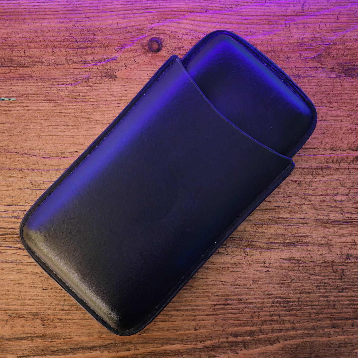 Black phone case on a wooden surface