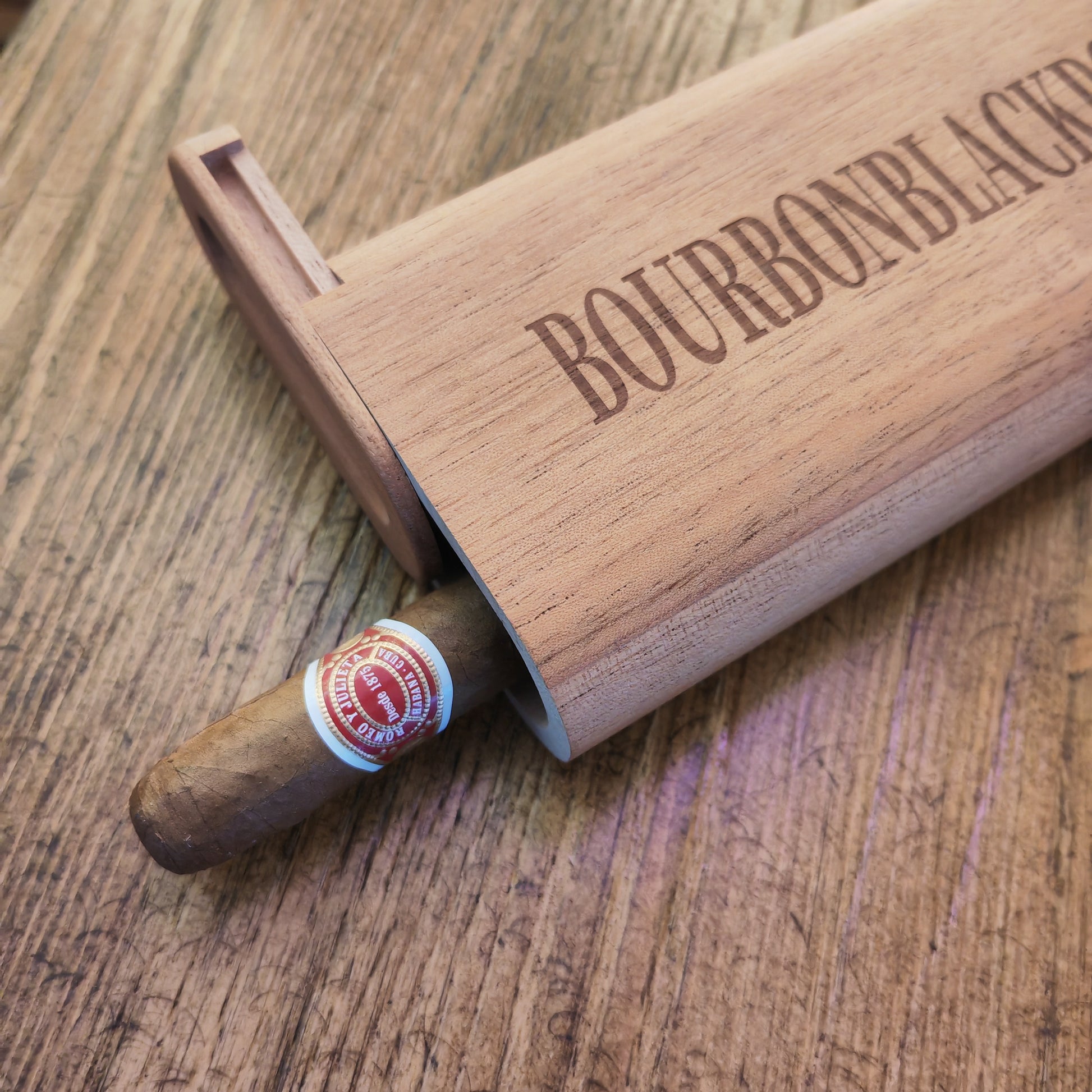 Wooden cigar case with cigar on table