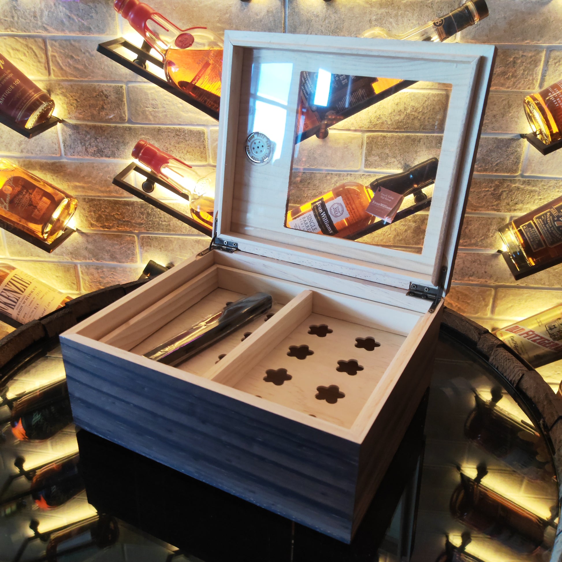 Wooden humidor with glass lid on a brick wall background