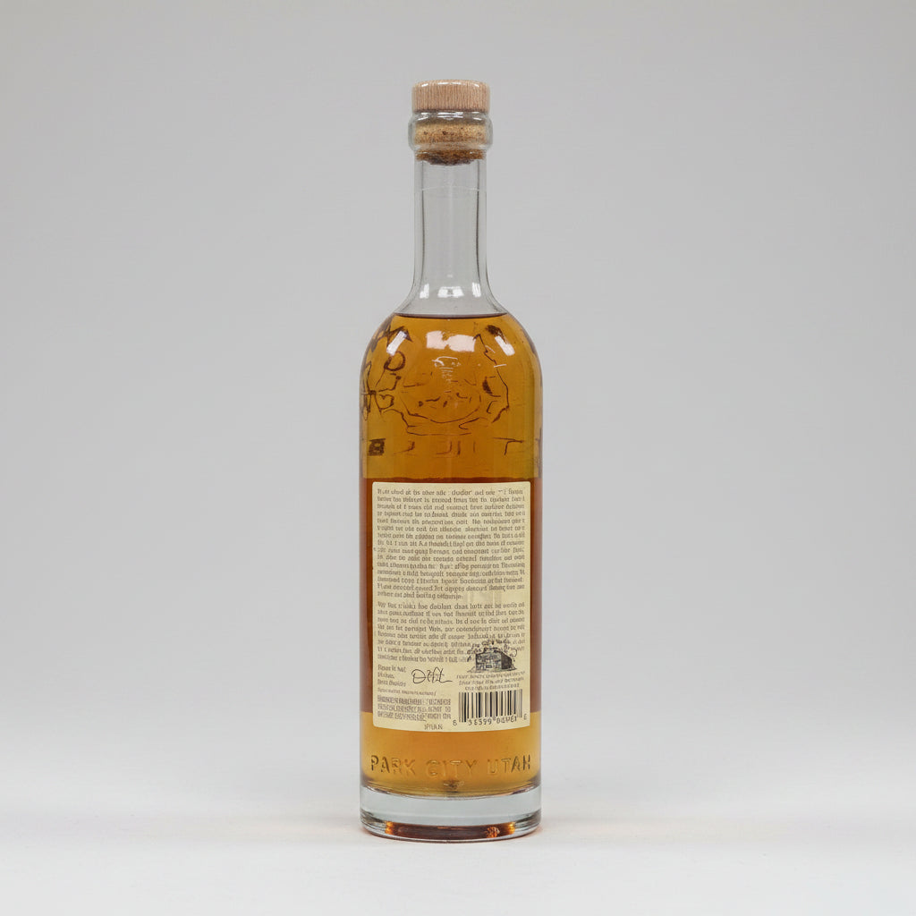 Bottle of alcohol with a cork stopper on a white background