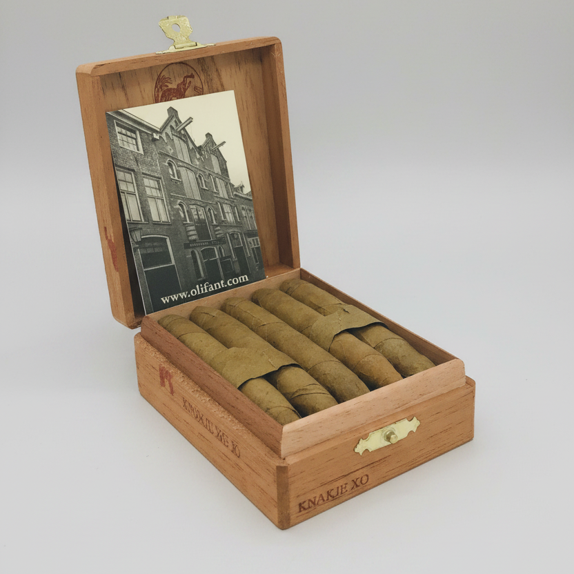 Wooden humidor with cigars and a vintage-style photo on a white background