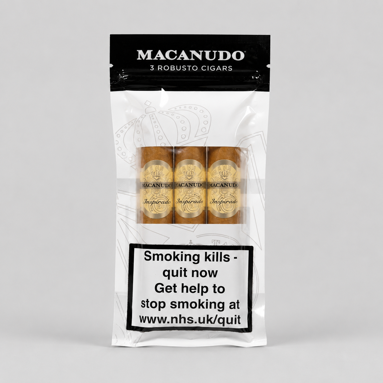 A package of Macanudo 3 Robusto Cigars on a light gray background. The white and black resealable pouch shows three cigars through a clear window, with a prominent smoking health warning label on the lower half.