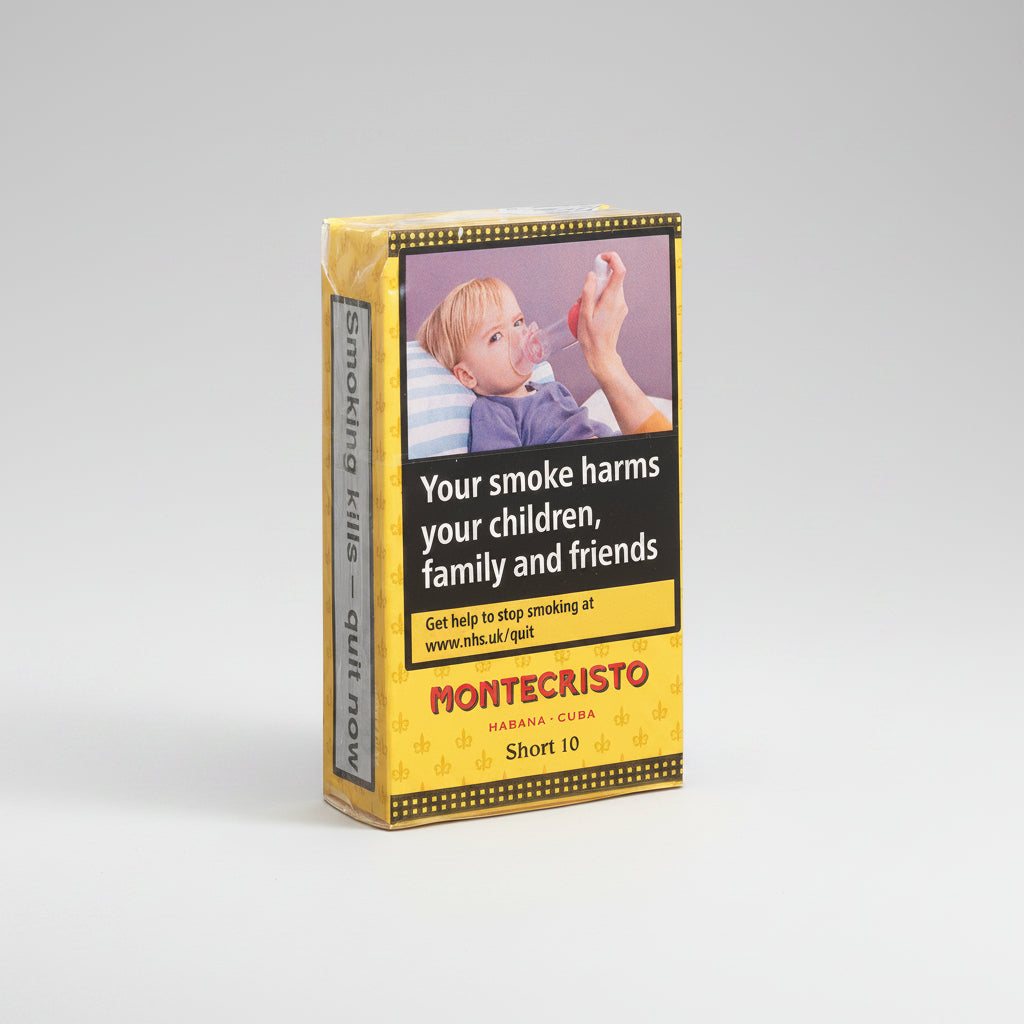 A pack of Montecristo Havana-Cuba Short 10 cigarettes on a clean white background. The packaging features a prominent health warning label with a photo of a child smoking and the text 'Your smoke harms your children, family and friends'.