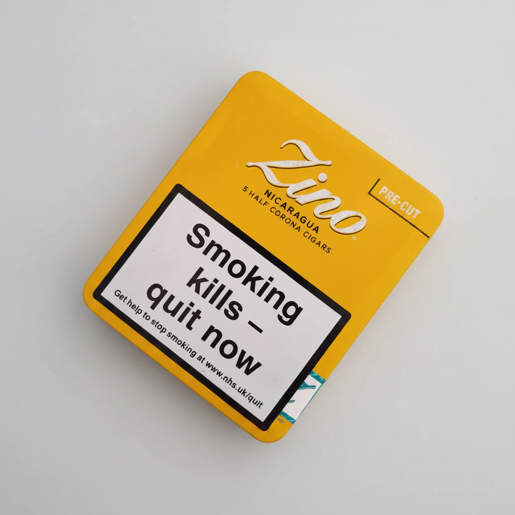 Zino cigar packaging with a warning label on a gray surface