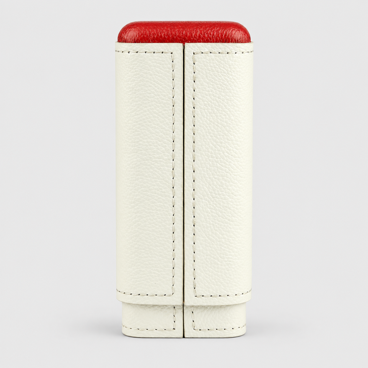 A cream-colored textured leather pouch with a vibrant red top lid, shown against a neutral light gray background.