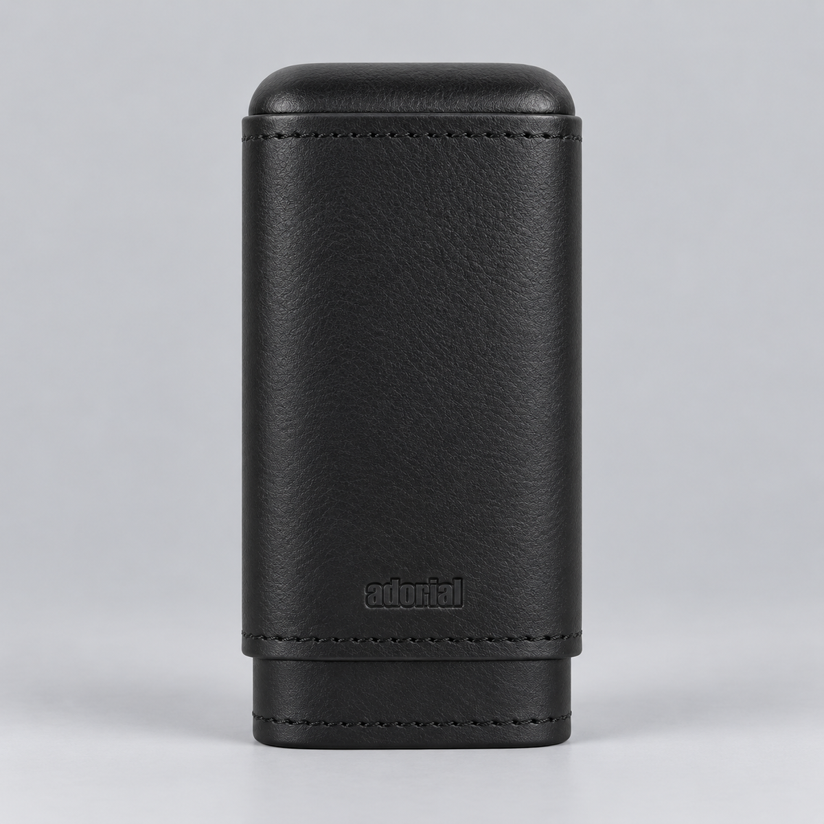 A black textured leather cigar case with stitched edges and a debossed 'adorial' logo, shown on a neutral gray background.
