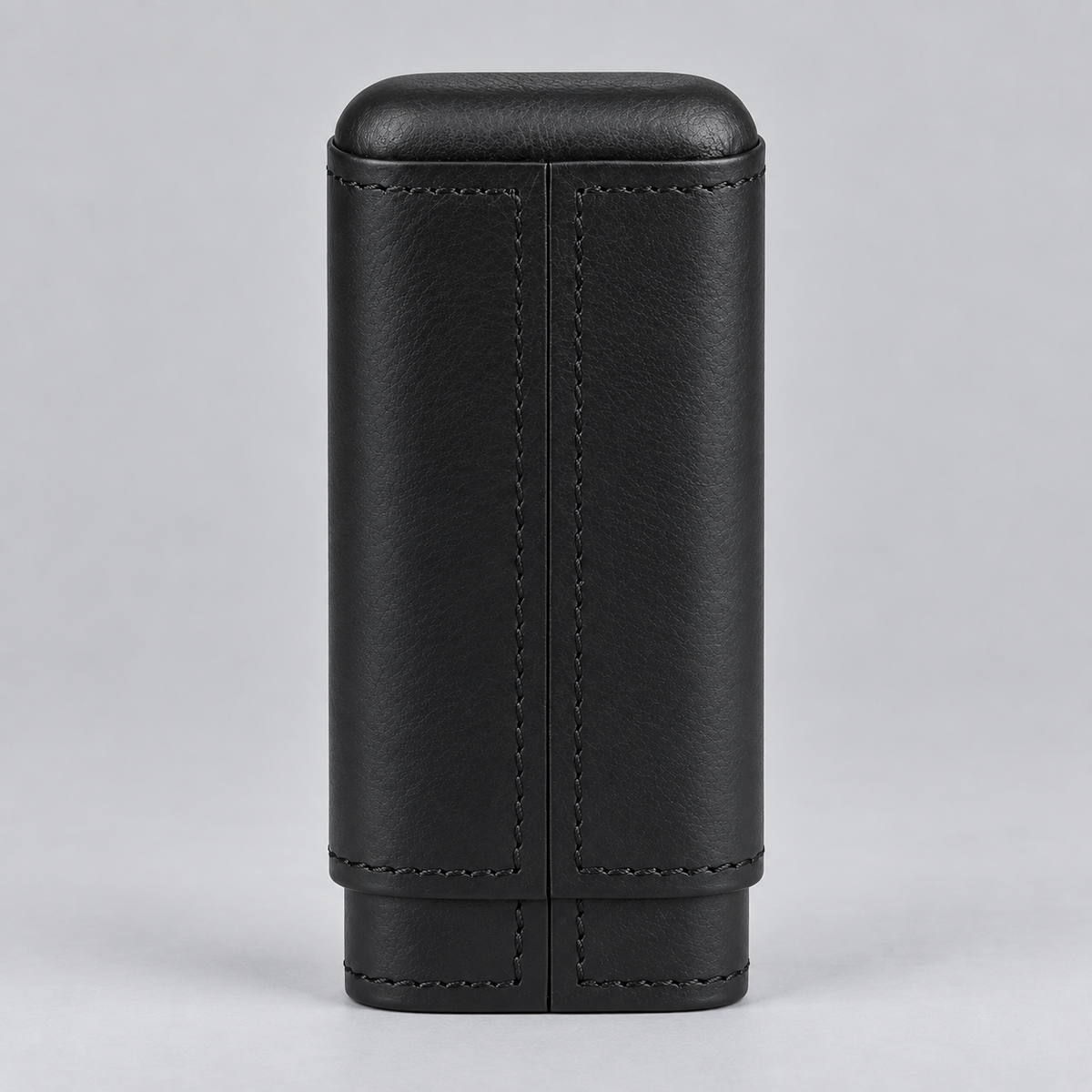 A black leather cigar case with a textured finish, visible stitching, and a rounded top, shown against a neutral gray background.