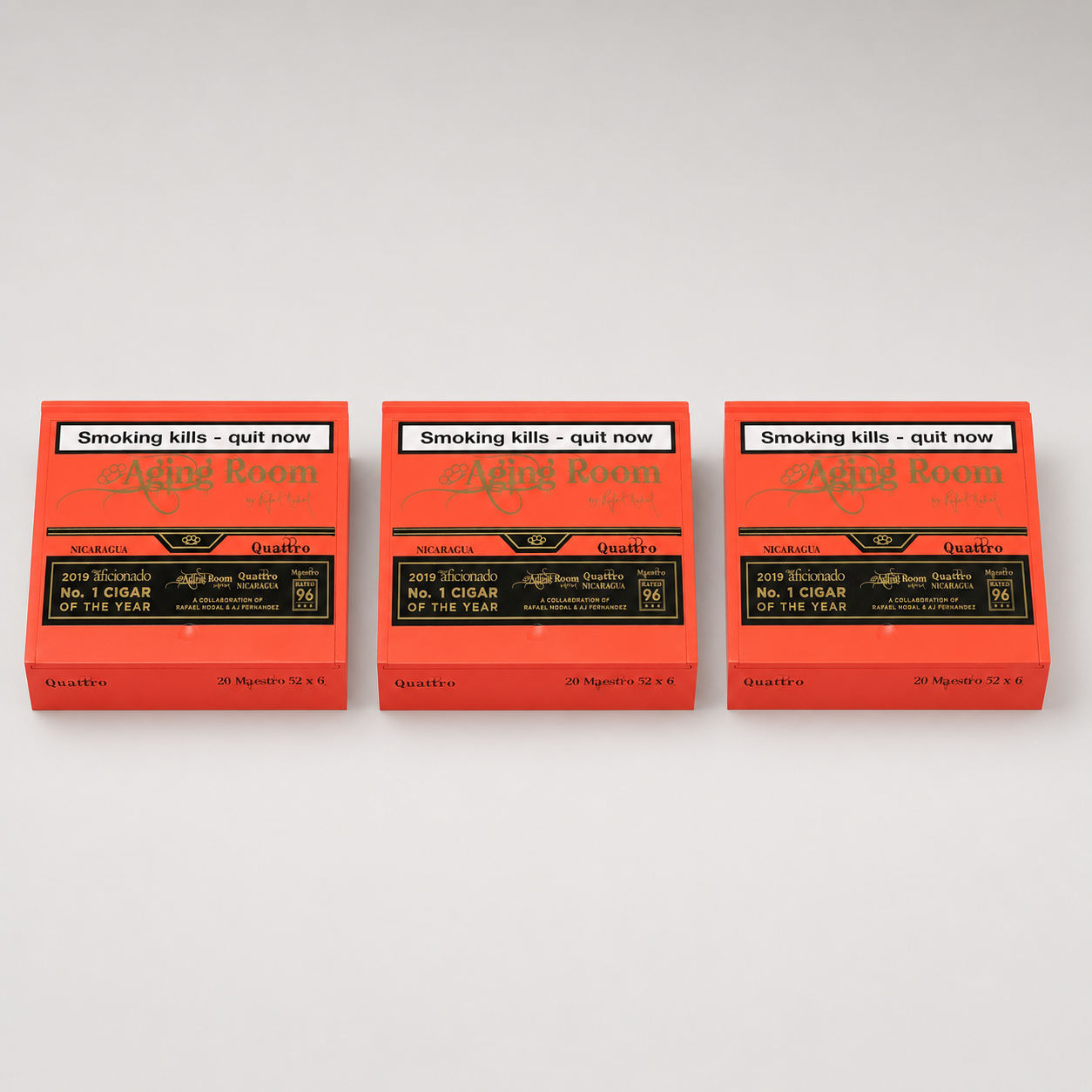 Three orange boxes of Aging Room Smoking Kills nicotine pouches arranged side by side on a light gray background. Each box features a black label with gold text and a white warning banner at the top that reads 'Smoking kills - quit now'.