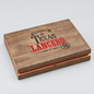 A rectangular wooden keepsake box with a hinged lid, featuring a custom engraved design on the lid. The design includes the text 'ALICE BRADLEY', 'TEXAS', 'LANCERO', and '70' in black and red western-style typography.