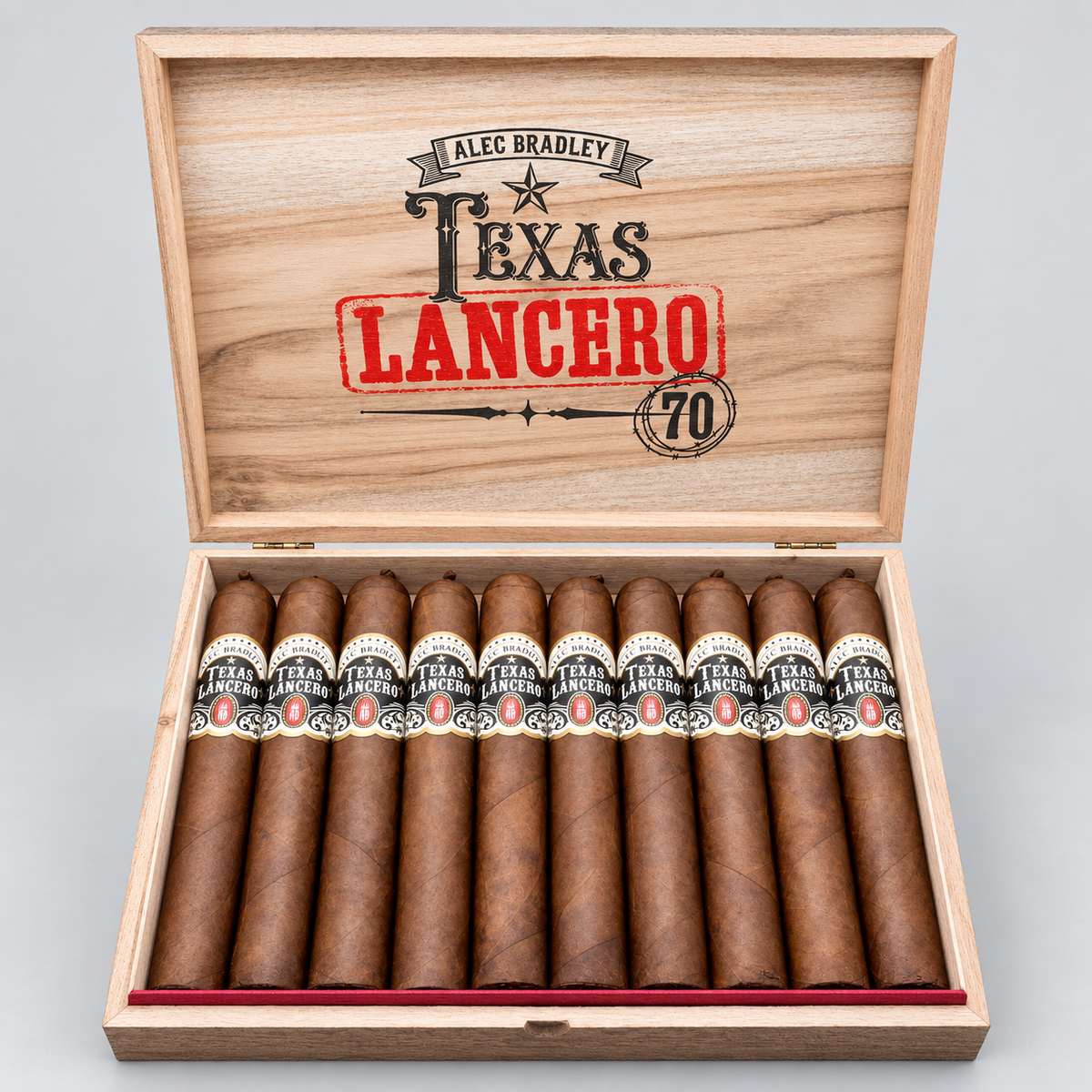 An open wooden cigar box with ten cigars inside, photographed on a light gray background. The box lid is printed with the text 'ALEC BRADLEY TEXAS LANCERO 70' in black and red.