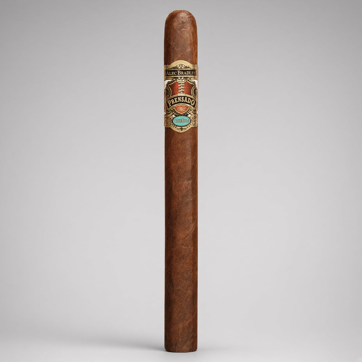 A single premium cigar standing upright against a neutral light gray background. The cigar has a rich medium-brown wrapper with a detailed silver, gold, and turquoise band from the brand Los Altos.