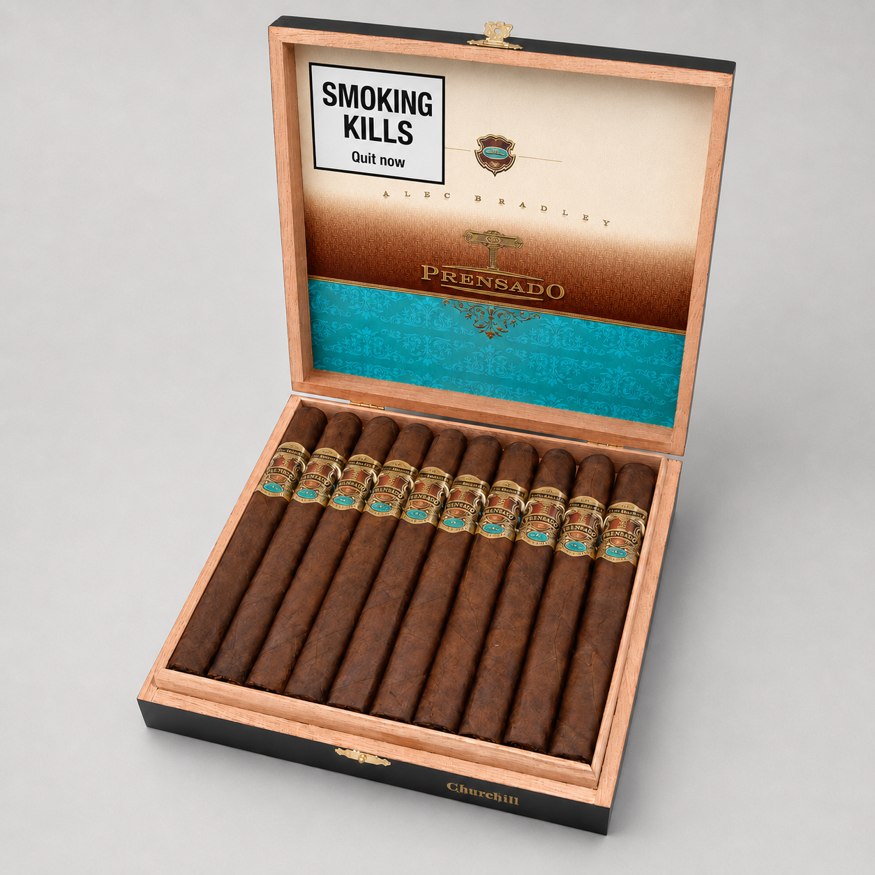An open wooden cigar box on a light gray background, containing ten dark brown cigars with gold and turquoise bands. The inside lid features a printed panel with the text 'SMOKING KILLS' and the brand name 'PRENSADO'.
