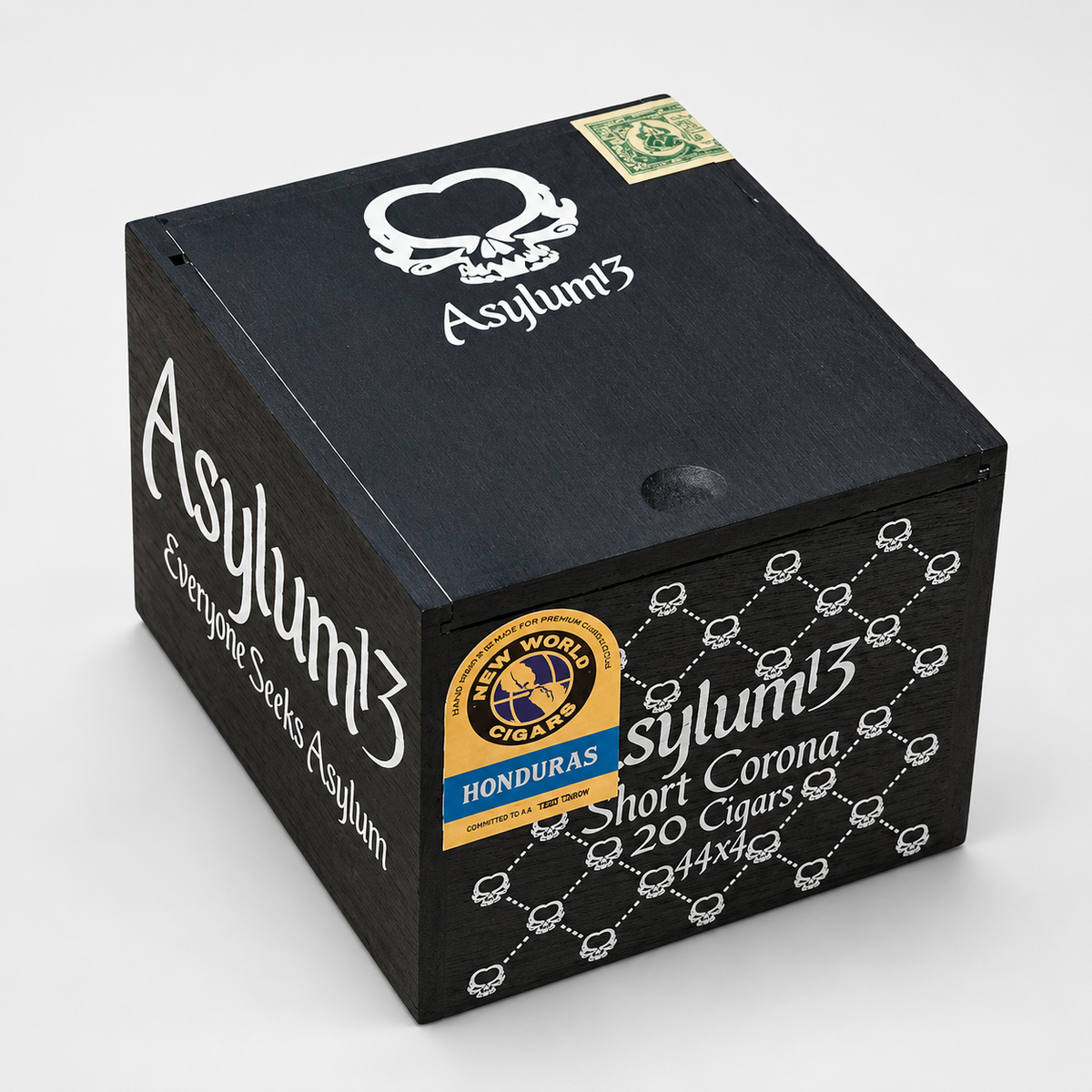 A black wooden cigar box for Asylum3 'Short Corona' featuring white text and graphics, a gold and blue Honduras seal, and a skull logo on a light gray background.