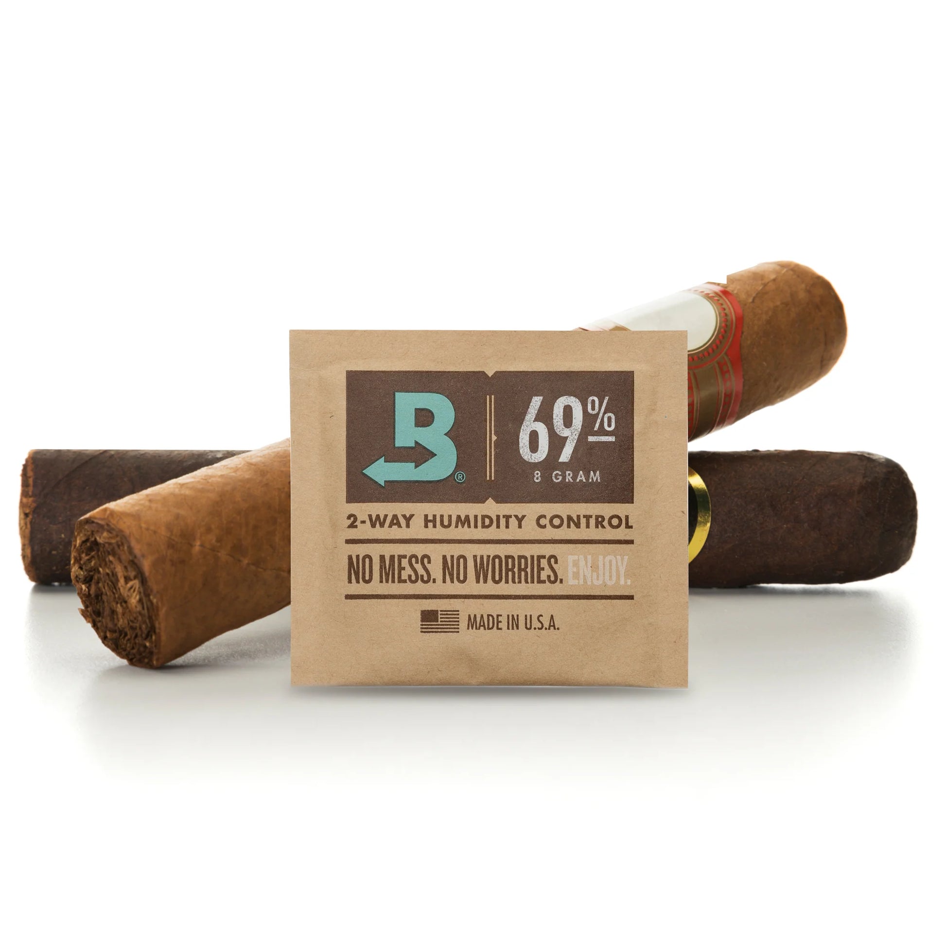 A pack of Boveda 69% 2-way humidity control packets, shown with three cigars behind it on a clean white background.