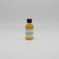 Small bottle of Balcones baby blue with a black cap and white label on a white background