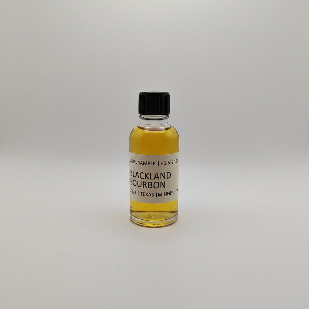 Small bottle of Blackland Bourbon on a light gray background