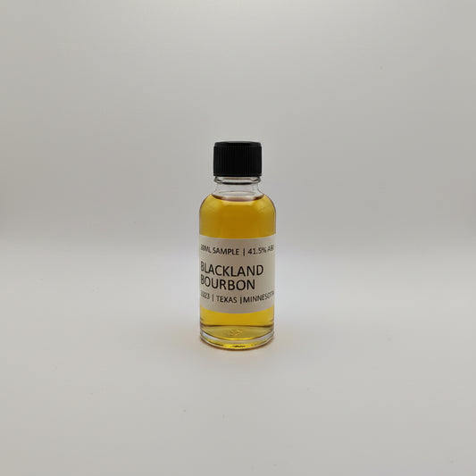 Small bottle of Blackland Bourbon on a light gray background
