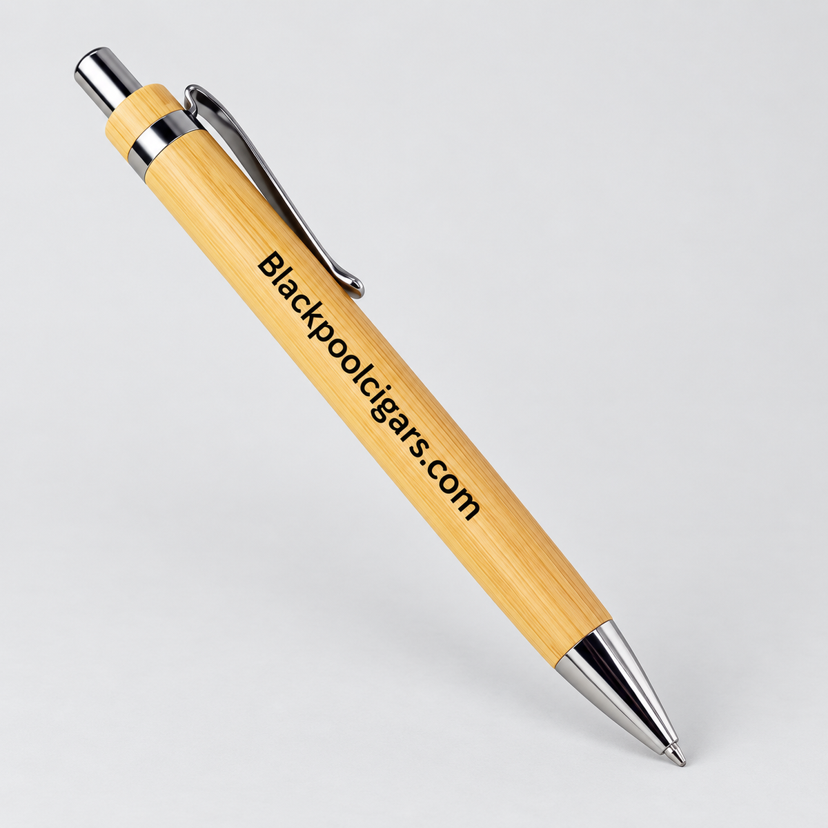 A bamboo pen with a silver metal clip, tip, and band, featuring the text 'Blackpoolcigars.com' printed on the barrel, shown on a light gray background.