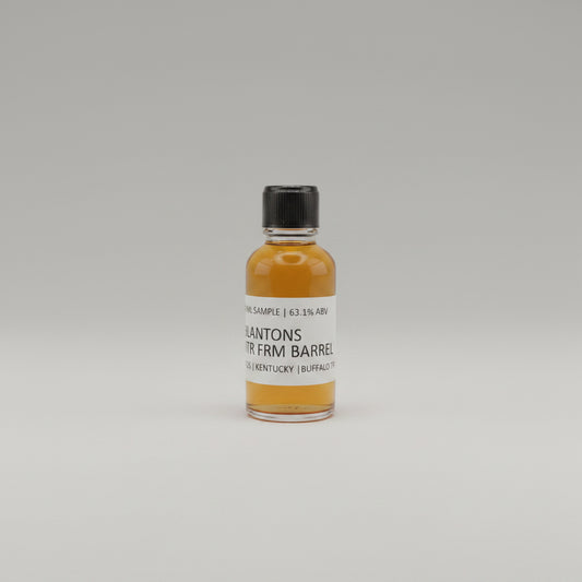 Small bottle of Blantons Whiskey on a beige background