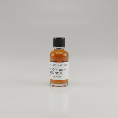 Small bottle of Blood Oath Whiskey Sample on a light pink background