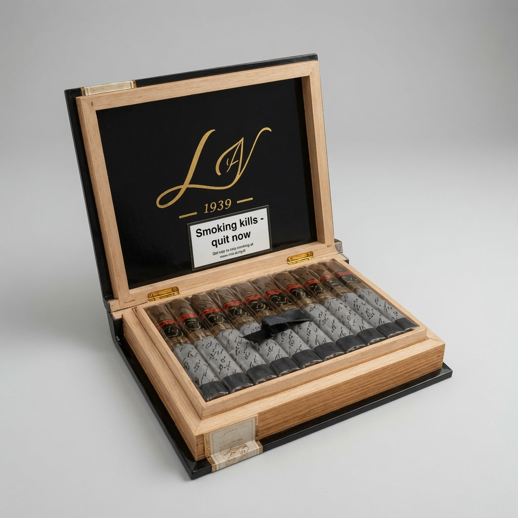 An open wooden cigar humidor box with a black interior lid featuring a gold script logo and a white warning label. Inside, multiple cigars with dark wrappers are arranged in a black tray.
