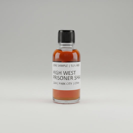 Bottle of High West Prisoner Sherry whiskey on a reflective surface with blurred background