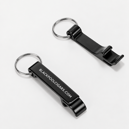 Two black metal keychain bottle openers with silver split rings, one showing the white printed text 'BLACKPOOL.CIGARS.