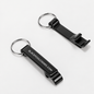 Two black metal keychain bottle openers with silver split rings, one showing the white printed text 'BLACKPOOL.CIGARS.