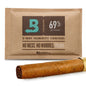 Humidity control pack for cigars with a brown wrapper on a white background