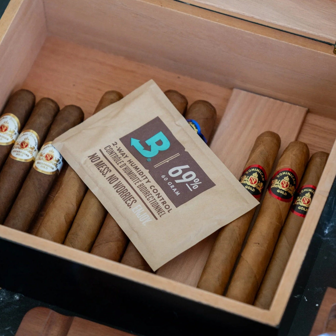 Cigar box with cigars and a B69 label on a marble surface