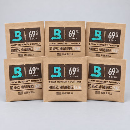 Six brown kraft paper packets of Boveda 69% 4 gram 2-way humidity control salts arranged in two rows on a light gray background.