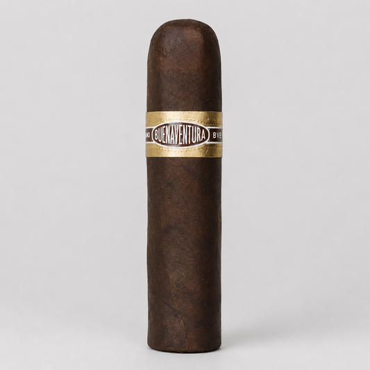A single dark brown cigar standing upright against a light gray background, featuring a gold and black band with the text 'Cruavenchura' and 'B Ent.'.