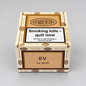 A box of BuenaVentura 20 Mini Semilla Curana cigars on a neutral gray background. The packaging features a light wood-grain textured design with dark brown accents and a prominent black and white health warning label on the front.