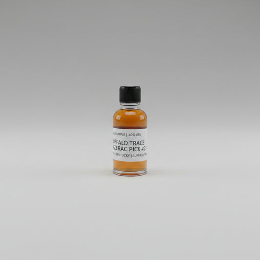 Small bottle of Buffalo Trace whiskey sample with a label on a beige background