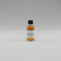 Small bottle of Buffalo Trace whiskey sample with a label on a beige background