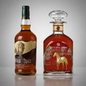 Two whiskey bottles on a light gray studio background: a clear glass bottle of Buffalo Trace Kentucky Straight Bourbon Whiskey Barrel pick with amber liquid and a tan/brown label, and a red Rock Hill Farms Single Barrel Collection decanter with a clear stopper and gold horse artwork.