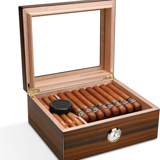 Wooden humidor with glass top containing cigars and a humidifier on a white background
