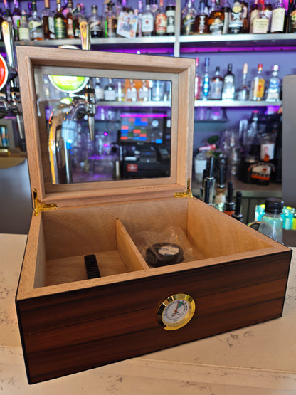 Wooden humidor with a mirror on top in a bar setting