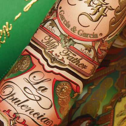 A close-up of decorative gift ribbon packaging with printed labels reading 'My Father,' 'La Ornelaneta,' and 'My Father -,' alongside a bright green ribbon with gold script and an illustrated vintage-style label.