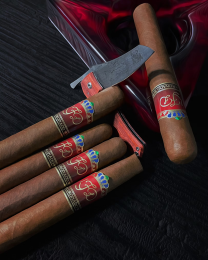 Cigars with decorative bands and a cutter on a dark surface