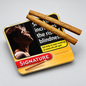 A tin of Signature Original cigars on a light gray background, with two cigars resting diagonally across the top of the tin. The tin features a yellow and black design with a warning label and a red Signature logo.