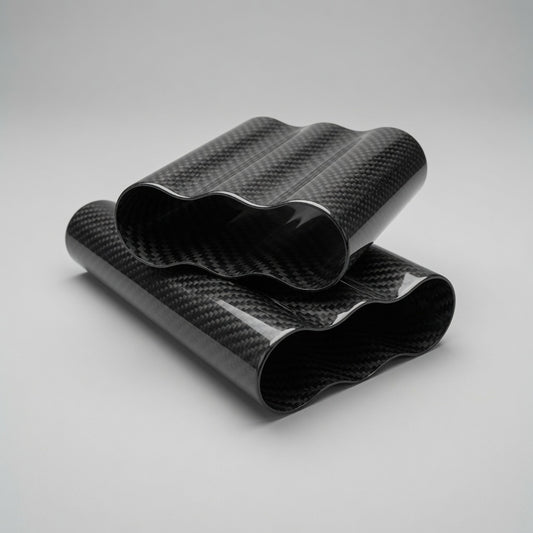 Two rolled sheets of glossy black carbon fiber wrap with a wavy pattern, displayed on a neutral light gray background.
